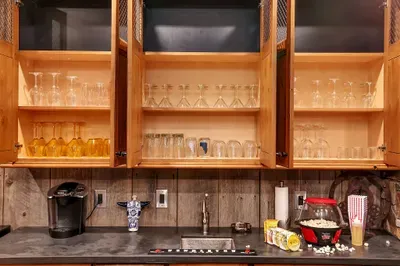 This level becomes the hub: theater next door, bar steps away, and a fireplace that anchors late‑night stories. We've got the glassware, you bring the vibe