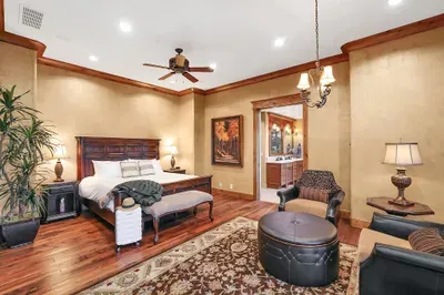 The primary suite is a true sanctuary—king bed, wood‑burning hearth, and tree‑level views that quiet the mind