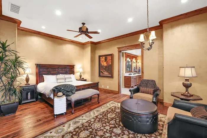 The primary suite is a true sanctuary—king bed, wood‑burning hearth, and tree‑level views that quiet the mind