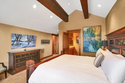 Thoughtful finishes define this east-facing retreat—walk-in closet, cozy king bed, artisan tile, a generous trough sink, and a spa-like walk-in shower