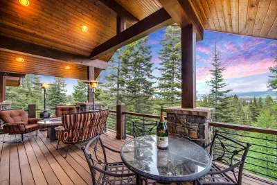 Open the doors and let the lodge spill onto the wraparound deck. Mountain and lake in every direction, effortless indoor‑outdoor living.