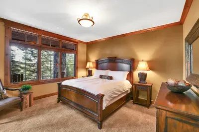 Ground-level king suite with direct access to the lower patio and hot tub—step out for a soak under the pines, then settle into a quiet, restorative room
