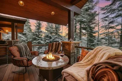 Step out from the great room or primary suite onto expansive decking that wraps the lodge—lake views, forest quiet, and room for the whole crew