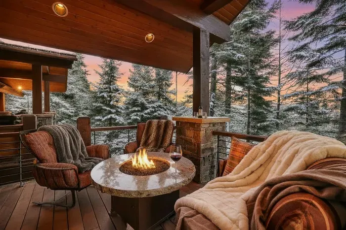 Step out from the great room or primary suite onto expansive decking that wraps the lodge—lake views, forest quiet, and room for the whole crew