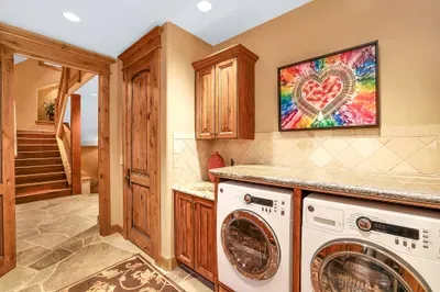 Thoughtful utility: counter space and sink for essentials, baskets for layers, boots by the door. Toss a load in and step back into the great room