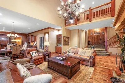 Timber beams, stone hearth, and tree‑level views—the great room sets the Lodge’s tone