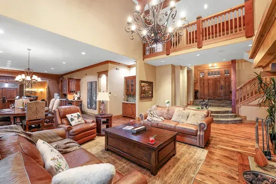 Timber beams, stone hearth, and tree‑level views—the great room sets the Lodge’s tone