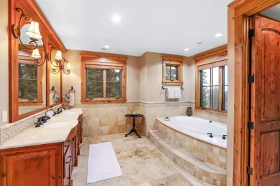A spa‑worthy bath anchors the suite with a steam shower and deep soaking tub made for slow mornings. Radiant floors warm bare feet as you move from bath to balcony, coffee in hand.