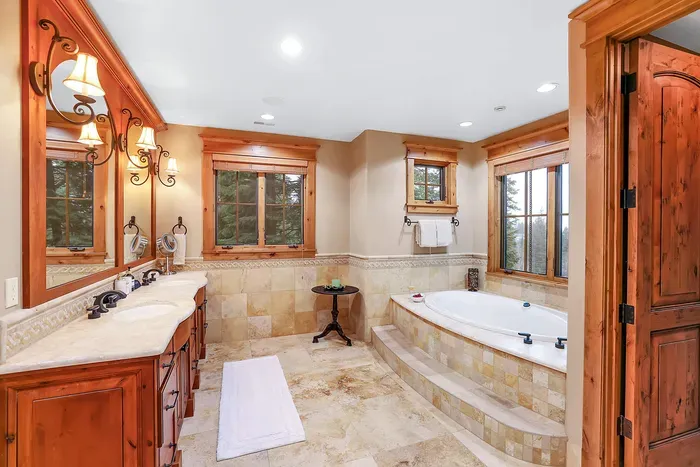 A spa‑worthy bath anchors the suite with a steam shower and deep soaking tub made for slow mornings. Radiant floors warm bare feet as you move from bath to balcony, coffee in hand.