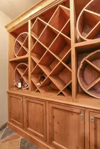Pull a bottle from the walk‑in wine cellar and settle by the flames while snow settles on the pines outside
