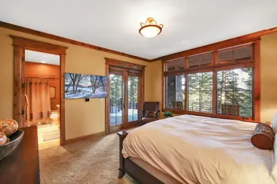 Unhurried nights, simple mornings—king bed, an ensuite with a shower/tub combo, and a few steps to the hot tub and fire pit on the lower patio