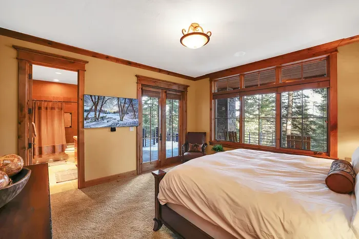 Unhurried nights, simple mornings—king bed, an ensuite with a shower/tub combo, and a few steps to the hot tub and fire pit on the lower patio