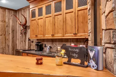 Mix, toast, repeat. The bar’s sink, dishwasher, and beverage fridge keep the evening effortless