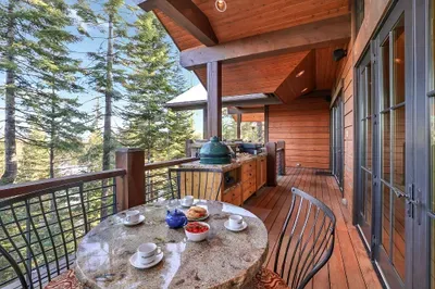 From sunrise to starlight, the wraparound balcony keeps you outside longer—gas fire pit, plenty of seating, and panoramas in every direction