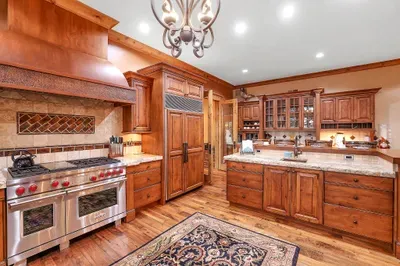 Wolf and Subzero anchor a chef’s kitchen built for gathering. Prep on butcher block, cook together, and let the island become the evening’s starting line