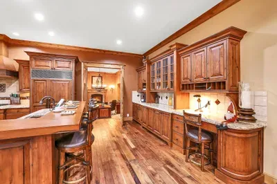 Walls of cabinetry and deep drawers swallow a week’s provisions and every tool, keeping counters clear and the kitchen ready for a crowd.
