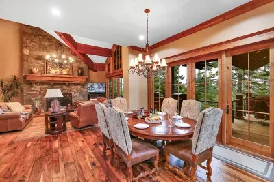 Open flow to the great room keeps the cook in the conversation. Plates move from range to long table to the wraparound deck without missing a beat