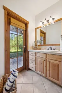 The guest bedroom has its own private bathroom, which also has outdoor access to the lower patio and hot tub