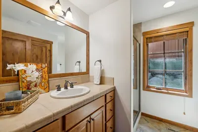 The main floor has a full bathroom with a walk-in shower, as well as an in-unit washer/dryer