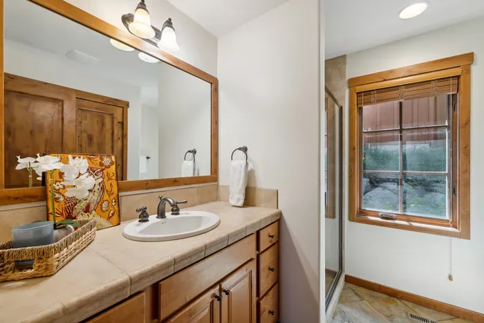 The main floor has a full bathroom with a walk-in shower, as well as an in-unit washer/dryer