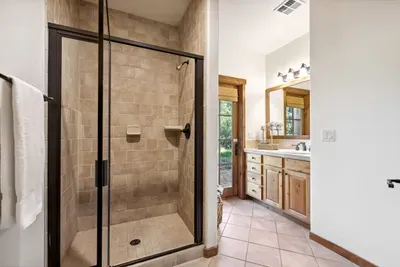 The guest bedroom has its own private bathroom with a walk-in shower