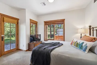 The guest bedroom (located in the daylight basement) is also spacious, has a queen bed, and offers convenient access to the private hot tub