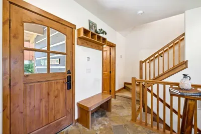 The entryway--making great use of the space with functional built-in storage and a bench
