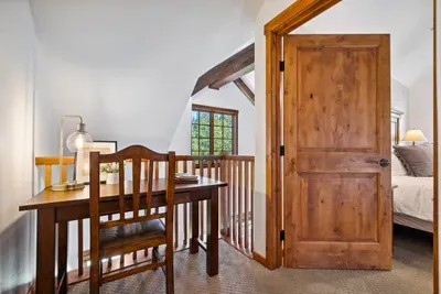 The upstairs loft offers a dedicated workspace with a desk and chair