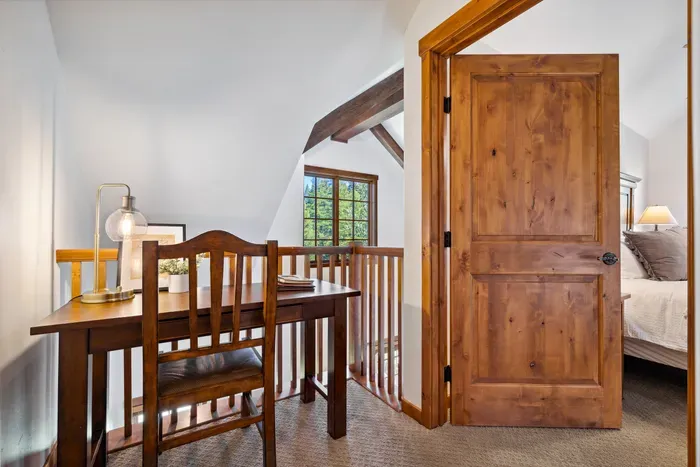 The upstairs loft offers a dedicated workspace with a desk and chair