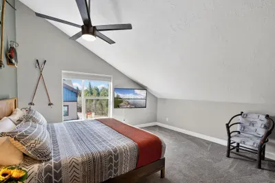 The top‑floor primary bedroom offers a plush king bed, smart TV, mountain‑modern decor, and a peaceful retreat to recharge after full McCall adventure days.
