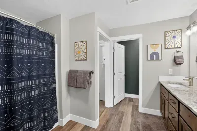 Soak in the tub or rinse off a day of sunscreen and snow in the shower/tub combo primary bath.
