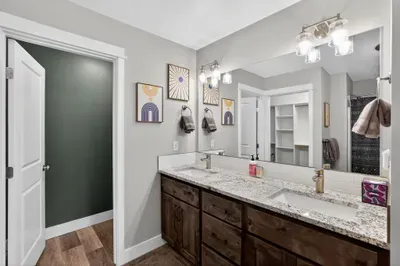 The primary bath keeps things easy and uncluttered with dual vanities, tons of counter space, and plenty of storage