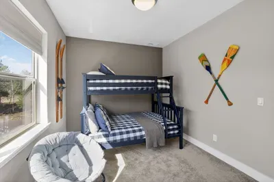 The cozy bunk room on the 2nd level brings vintage lake charm and is a hit with kids and adults alike (Twin/Full)