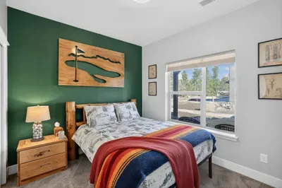 Golf‑themed decor in the 1st level queen room brings Jug Mountain and McCall Golf Club energy home.