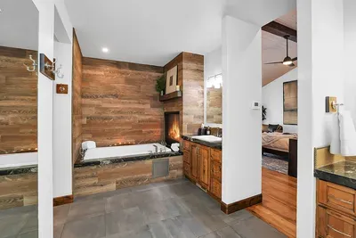 The spa‑style ensuite is built for lingering—massive steam shower, deep soaking tub, and a double‑sided fireplace you’ll remember.