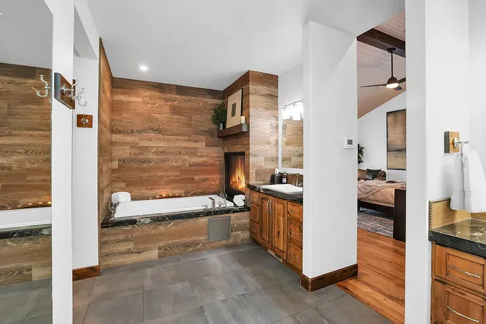 The spa‑style ensuite is built for lingering—massive steam shower, deep soaking tub, and a double‑sided fireplace you’ll remember.