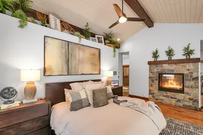 Primary suite made for recovery days: king bed, steam shower, deep soaking tub, and a double‑sided fireplace you’ll remember.