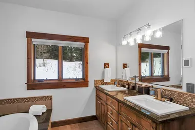With its own ensuite—walk‑in shower, soaking tub, and double vanity—it feels like a private mini‑retreat, not a “spare room.”
