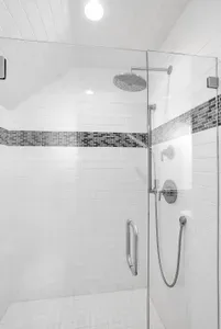Step into the apartment's full bath, featuring a beautifully tiled walk-in shower that offers a touch of luxury and a refreshing retreat.