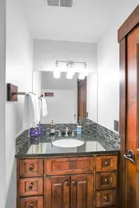 Enjoy the sleek design and comfort of the full bath, where a gorgeous tiled walk-in shower invites you to unwind and relax in style.