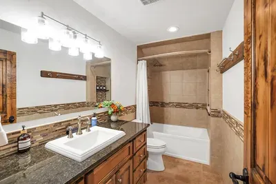 A full bathroom just outside the door keeps the loft bedroom feeling private and practical, without being closed off.