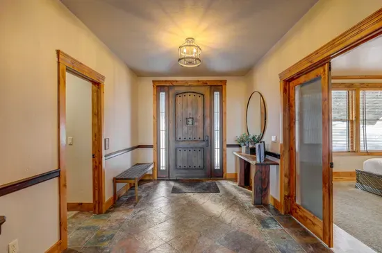 The main floor at Pinnacle Peak keeps everyone together without crowding—big kitchen, open dining with wraparound windows, vaulted living room with gas fireplace, plus a nearby king bedroom and bath for easy access