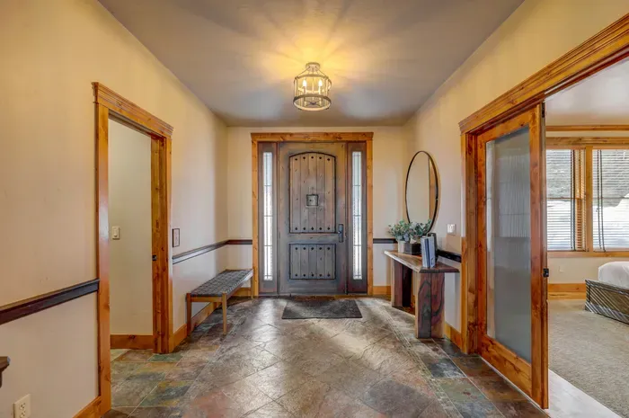 The main floor at Pinnacle Peak keeps everyone together without crowding—big kitchen, open dining with wraparound windows, vaulted living room with gas fireplace, plus a nearby king bedroom and bath for easy access