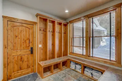 Gear up, wash up, and stow it all away—this mudroom + laundry combo features custom ski lockers and wall-to-wall storage to keep every adventure organized.
