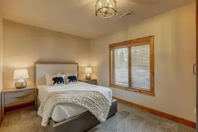Queen bedroom in the daylight basement. Real mattresses, real frames—no one’s stuck on a lumpy sofa bed