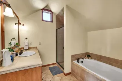 Luxury Ensuite: Indulge in the spa-like ensuite bathroom, complete with a large soaker tub and walk-in shower, providing a personal sanctuary for relaxation and pampering