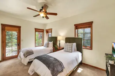 Practical and Cozy: The twin guest bedroom combines practicality with coziness, featuring ample storage, plenty of natural light, and comfortable sleeping options for a peaceful retreat