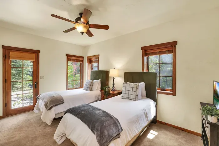 Practical and Cozy: The twin guest bedroom combines practicality with coziness, featuring ample storage, plenty of natural light, and comfortable sleeping options for a peaceful retreat