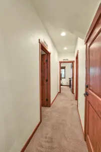 The two bedrooms share a jack-and-jill bathroom with a walk-in shower. The laundry room is on the right, with a large storage closet directly off the stairs