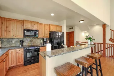 The open layout ensures everyone stays connected, whether you're cooking, dining, or lounging by the fire, making it ideal for gatherings and quality time